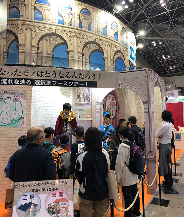 A booth tour guide wearing a Roman robe